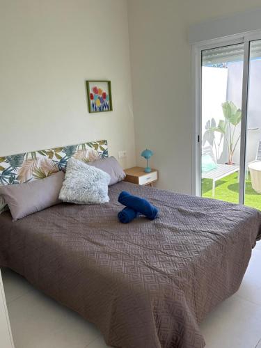 a large bed with a blue object on top of it at La Casita de Kai in El Médano