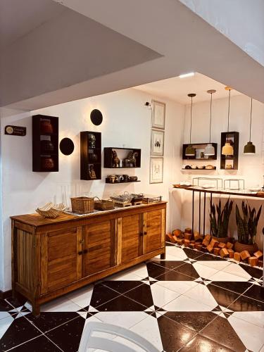 a room with a wooden counter and a black and white floor at Boutique Hotel Casa Teatro in Manaus