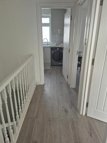 a hallway with a staircase and a kitchen in a house at One bed flat in UB5 in Northolt