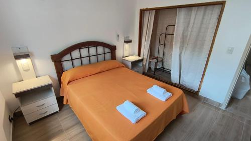 a bedroom with a bed with two pillows on it at Casa Celina in La Falda