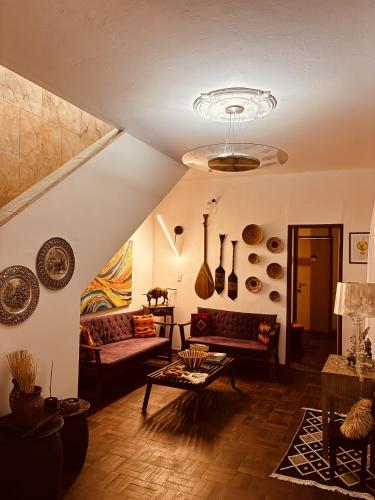 a living room with couches and a ceiling at Boutique Hotel Casa Teatro in Manaus