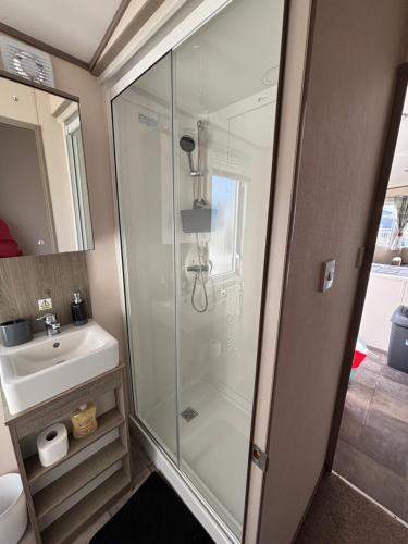 a bathroom with a shower and a sink at Oakley caravan rental in Skegness