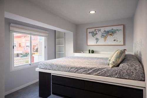 a bedroom with a large bed and a window at Suites Prieto Fuengirola Centro in Fuengirola