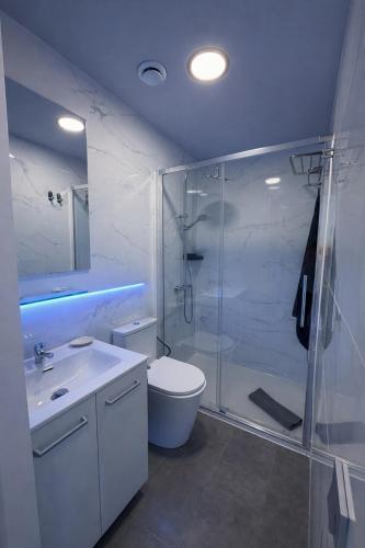 a bathroom with a shower and a toilet and a sink at Suites Prieto Fuengirola Centro in Fuengirola