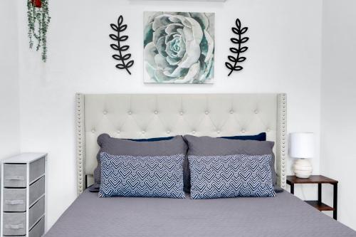 a bedroom with a bed with blue and white pillows at The Container Retreat - 1A.. in Canyon Lake