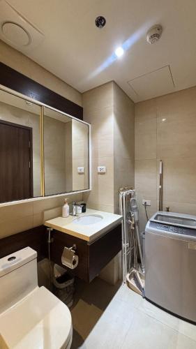 a bathroom with a toilet and a sink at 12th Floor Studio Tambuli, Sea View, Balcony in Maribago