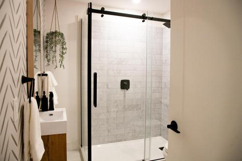 a bathroom with a shower with a glass door at Halifax's Most Popular Historic Modern Space in Halifax