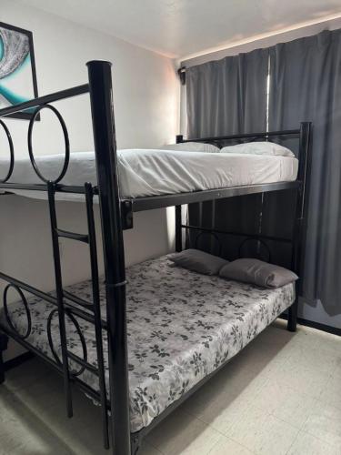 a couple of bunk beds in a room at Casa Alameda in Mexico City