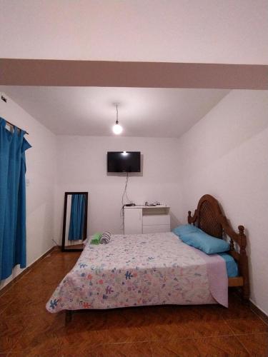 a bedroom with a bed and a flat screen tv at Lo del Tata in Villa Unión