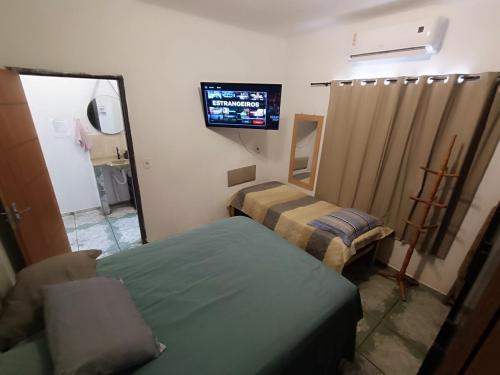 a hospital room with two beds and a television at Loft C Mobiliado e Bem Localizado com Ar condicionado in Dourados