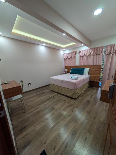 a bedroom with a bed and a wooden floor at Hotel & Plaza San Blas in Comayagua