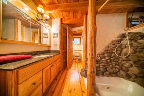 a bathroom with a sink and a tub in a cabin at Campfire Ranch All-Inclusive Lodge in Truckee