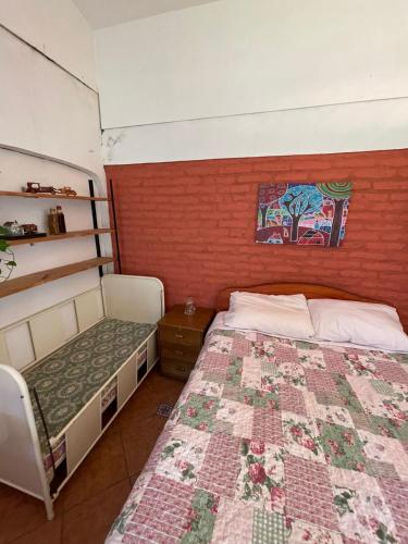 a bedroom with a bed with a quilt on it at Casa Ordóñez - Cielo Abierto in El Molino