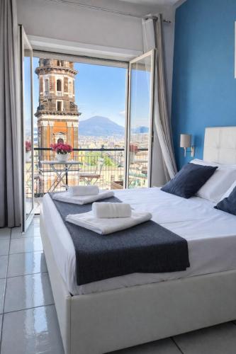 a bedroom with a large bed and a large window at La Casa di Giorgio Panoramic Rooms in Naples