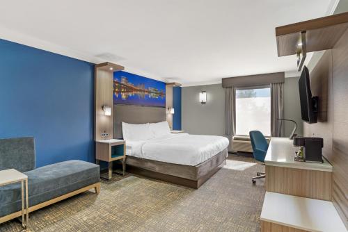 a hotel room with a bed and a tv at Best Western Plus Glen Allen Inn in Richmond