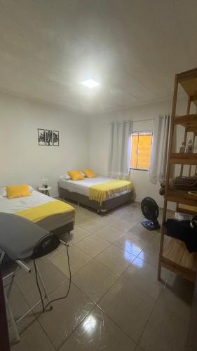 a room with two beds and a ladder in it at Casa com churrasqueira e piscina, perto de riacho in Angra dos Reis