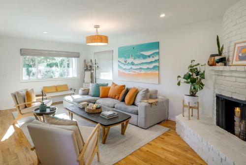 a living room with a couch and a fireplace at Seaside Home with Hot Tub and Patio Close to Beaches! in Seaside