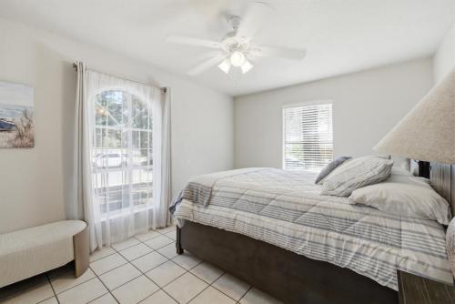 a white bedroom with a bed and a window at Private Beach Volleyball Pool Retreat in Las Cruces
