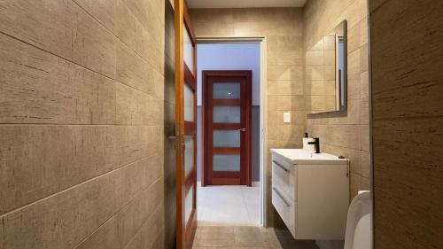 a bathroom with a sink and a toilet in it at RC Apartments Suriname in Paramaribo