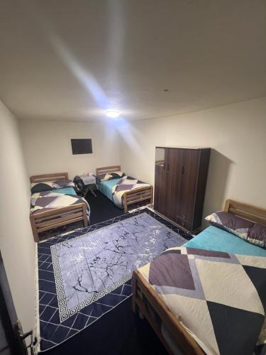 a room with three beds in a room with a spotlight at قمه التجلي in Saint Catherine