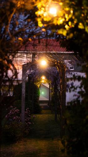an entrance to a house with an arch with flowers at Cantinho Dos Avós - Alojamento Local in Canas de Senhorim