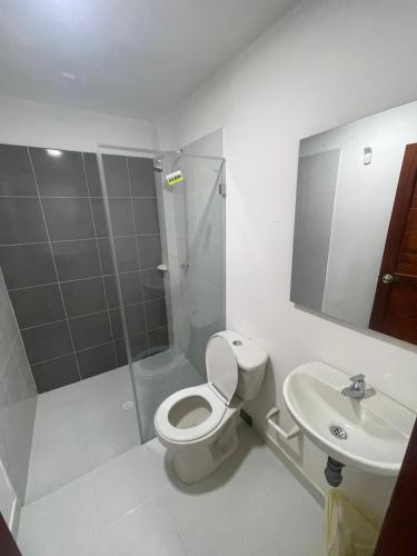 a bathroom with a shower and a toilet and a sink at AMAREA Hotel Boutique in Tolú