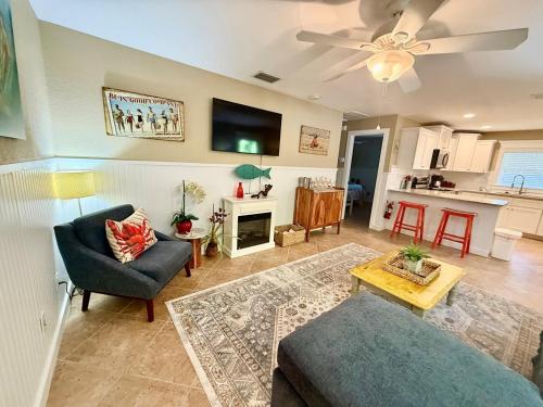 a living room with a couch and a table at Peacock Way bungalow in Holmes Beach