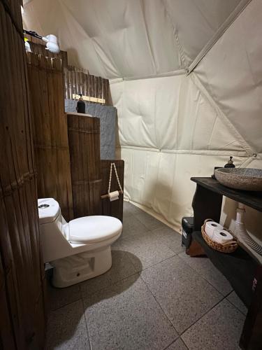 a bathroom with a toilet in a tent at Bambuk Bio Dome Uvita beach front in Uvita