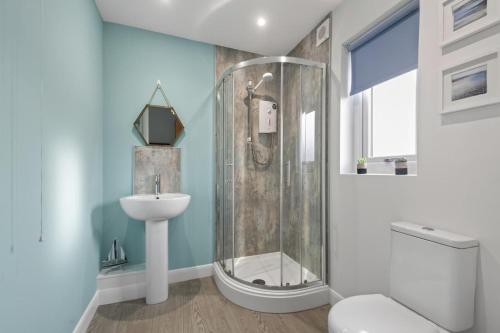 a bathroom with a shower and a sink at 3 Bed in Brynteg oc-d33659 in Brynteg
