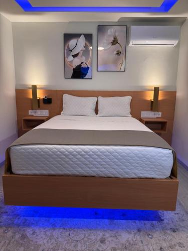 a bedroom with a large bed with blue lights at N3XT LEVEL home in Praia