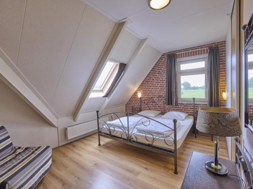 a bedroom with a bed and a brick wall at t Achterhoes in Neede