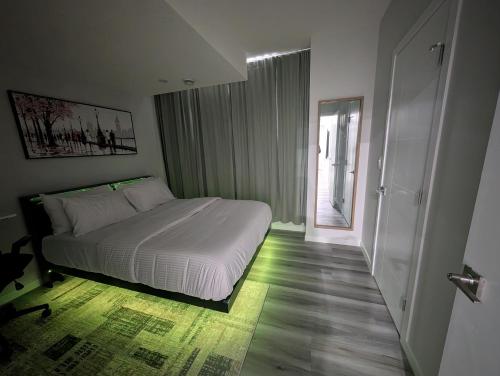a bedroom with a white bed and a window at Calgary Serene Suite - 19mins from airport, 1hr to Banff, 85" Cinema, Fibre WiFi, Full Kitchen in Calgary