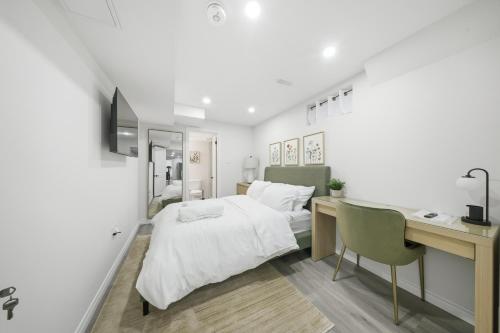 a white bedroom with a desk and a bed at Caledon Quiet Luxury Escape 3BR Suite in Brampton