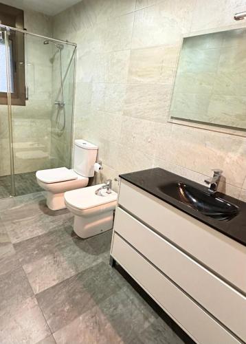 a bathroom with a toilet and a sink and a shower at CASA DEL MAR-Costa Daurada in Cunit