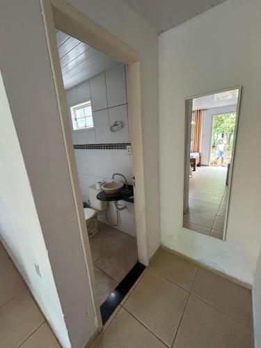 a small bathroom with a toilet and a mirror at Pousada do pc in Bom Jesus do Itabapoana
