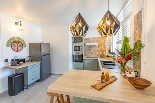 a kitchen with blue cabinets and a wooden table at Pointe Noire in Pointe-Noire
