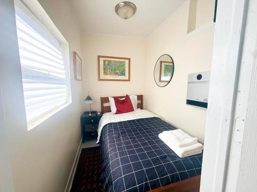 a bedroom with a bed with a blue plaid blanket at 7A - A Diamond in Yonkers in Yonkers