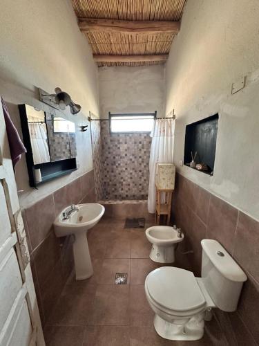 a bathroom with a toilet and a sink at Casa Chule in Fiambalá