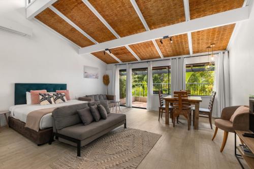 a bedroom with a bed and a table and chairs at Nautilus Beach Resort by Charlesworth in Coffs Harbour