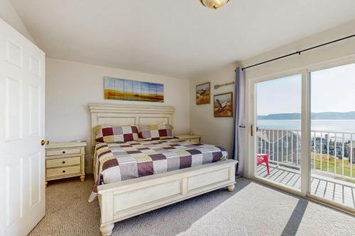 a bedroom with a bed and a balcony at Bear Lake View in Garden City