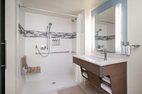 a bathroom with a sink and a shower at EVEN Hotel Rockville - Washington, DC Area by IHG in Rockville