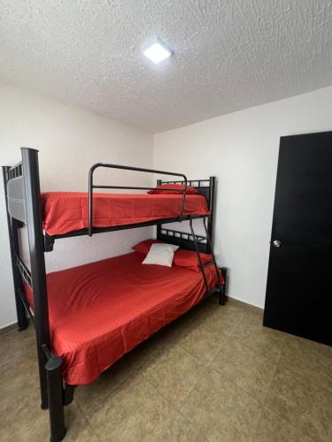 a bedroom with two bunk beds in a room at Departamento en Acapulco Diamante planta baja in La Sabana