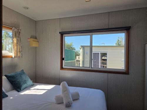a bedroom with a large bed and a window at Cooma Holiday Park in Cooma