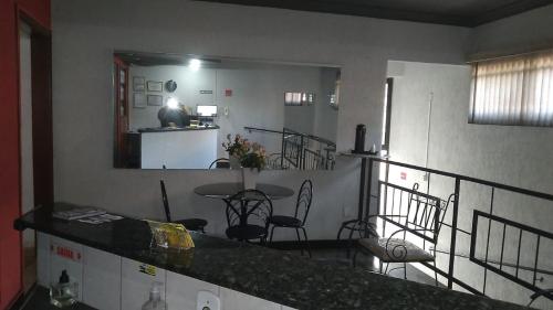 a kitchen and dining room with a table and chairs at HOTEL CENTER Ribeirão in Ribeirão Preto