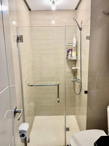 a shower with a glass door in a bathroom at Kings hotel Ph in Manila