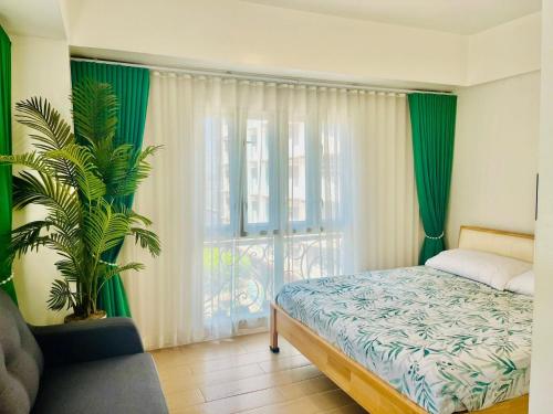 a bedroom with a bed and a large window at Kings hotel Ph in Manila