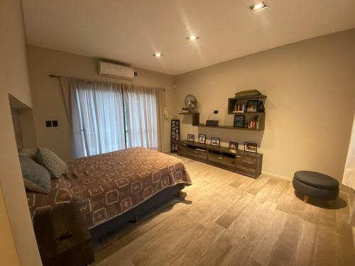 a bedroom with a bed and a chair in it at Casa Quinta in Córdoba