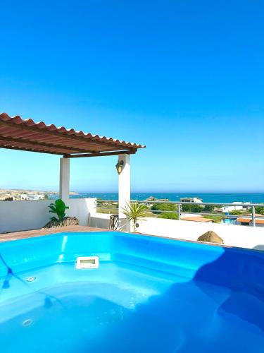 a swimming pool with a view of the ocean at Casa Norte North Beach in Los Órganos