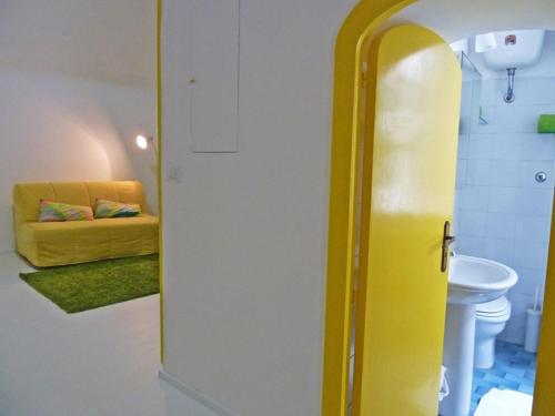 a yellow refrigerator in a room with a couch at Sciù Sciù House in Atrani