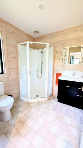 a bathroom with a shower and a toilet at Absolute Tranquility - surrounded by native bush in Kaiuma